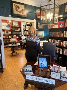 A picture of Diana McDonough with her book Ginger Star at the Greyhound Bookstore.